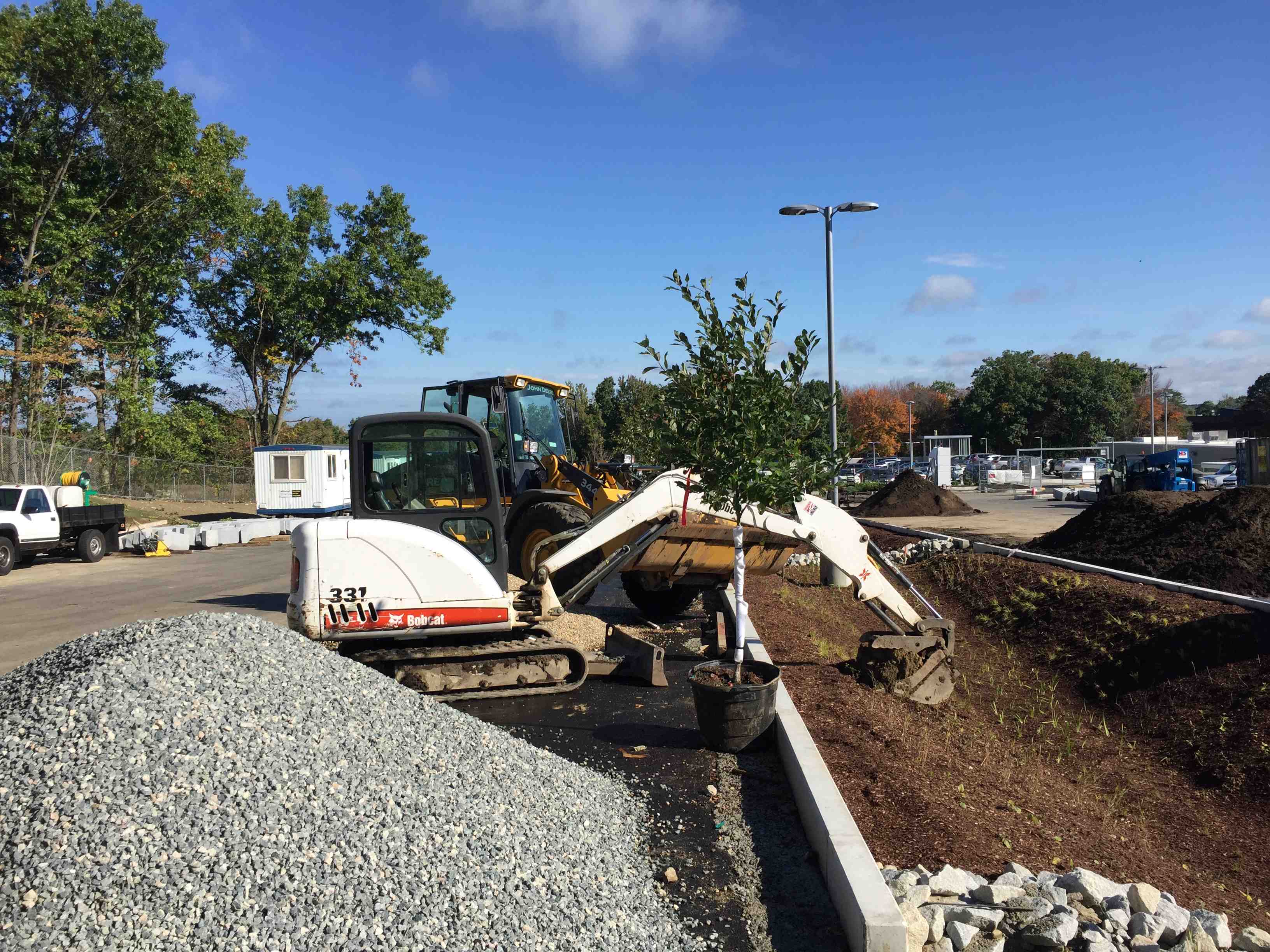 excavator digging a proper bowl-shaped pit for in-ground trampoline installation - can you put an above ground trampoline in the ground