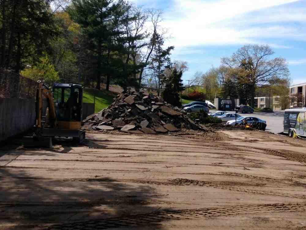 Excavation and footing preparation showing proper drainage installation - Cape Cod retaining walls