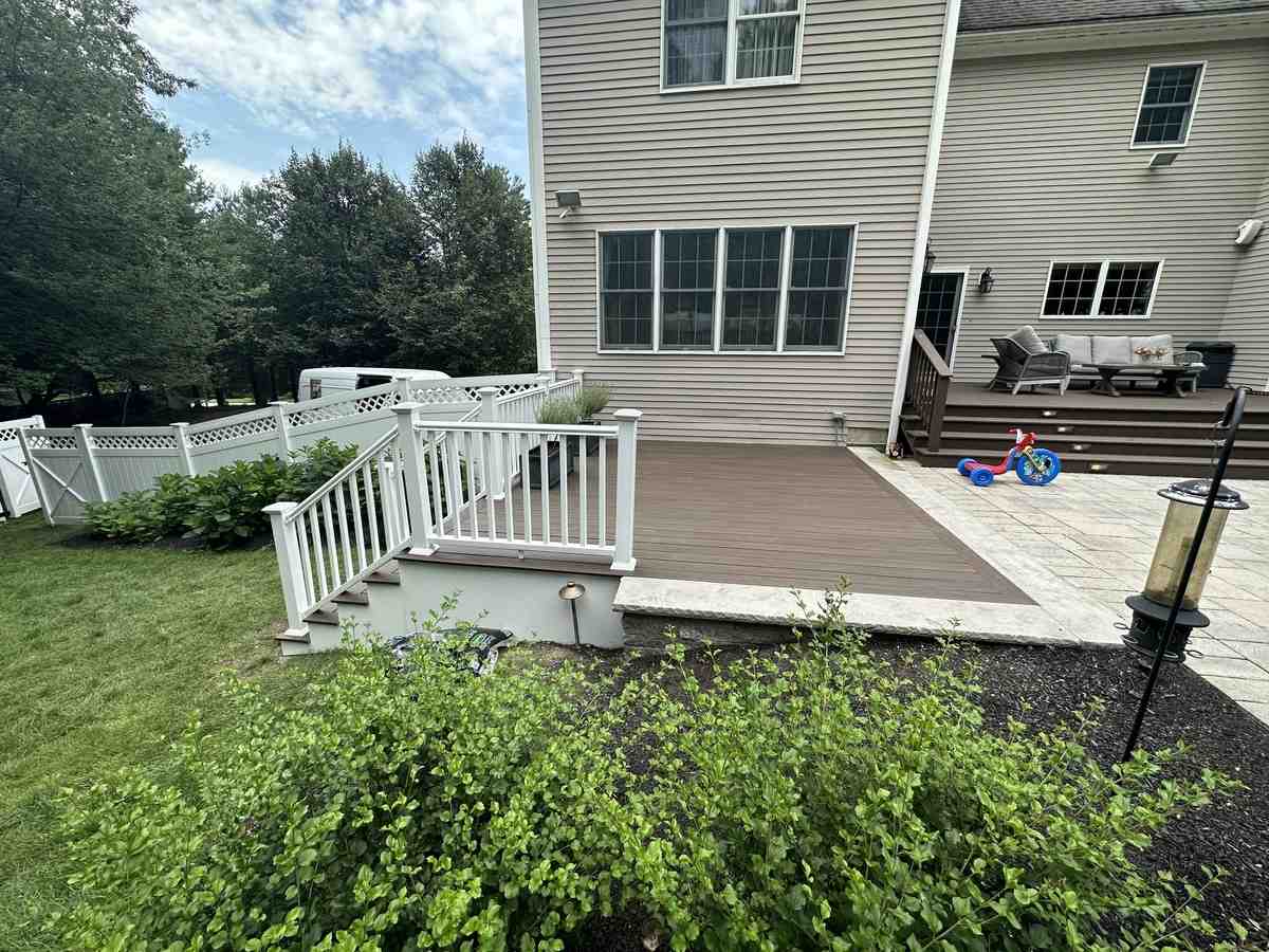 a beautifully finished composite deck with outdoor furniture - composite decking companies near me