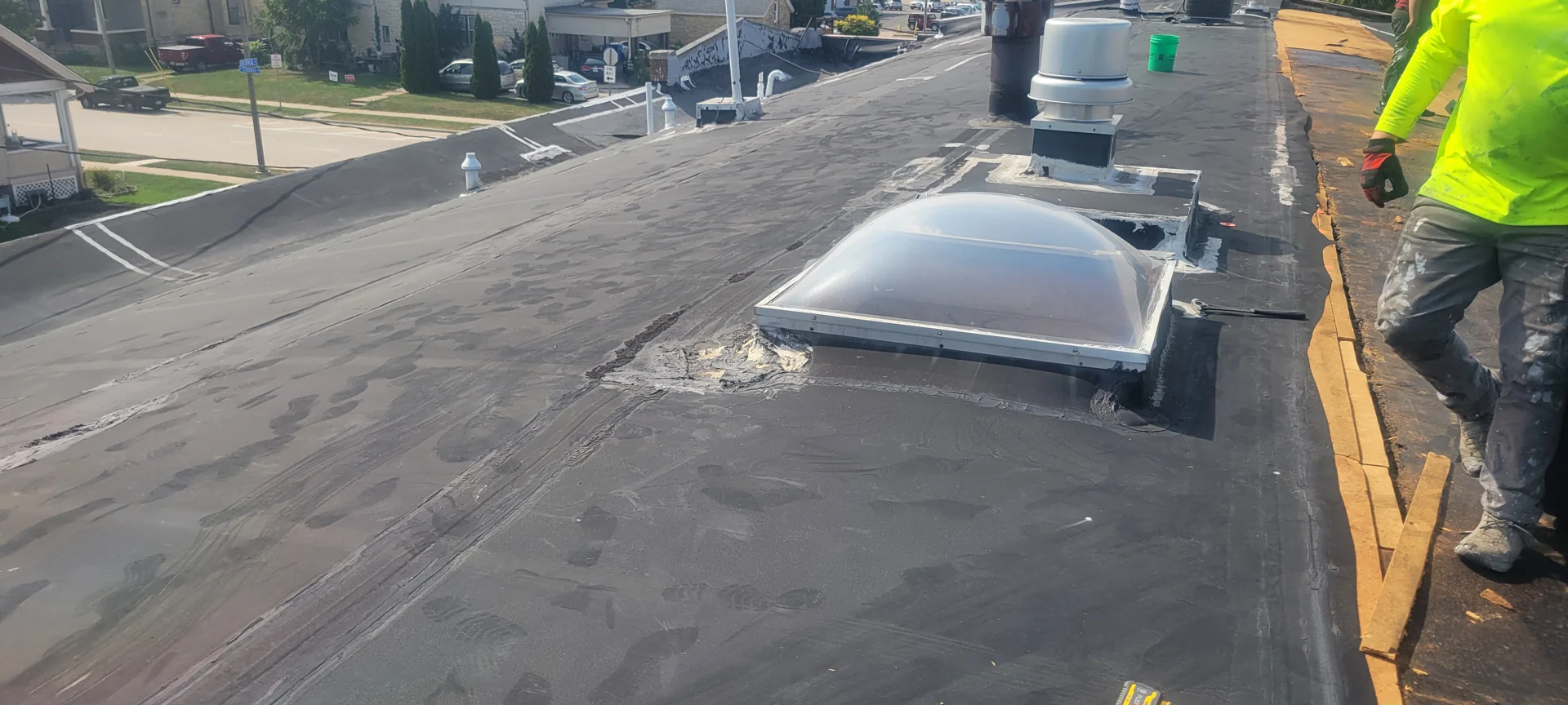 Commercial roofers installing EPDM membrane on a flat roof Commercial roofers installing EPDM membrane on a flat roof