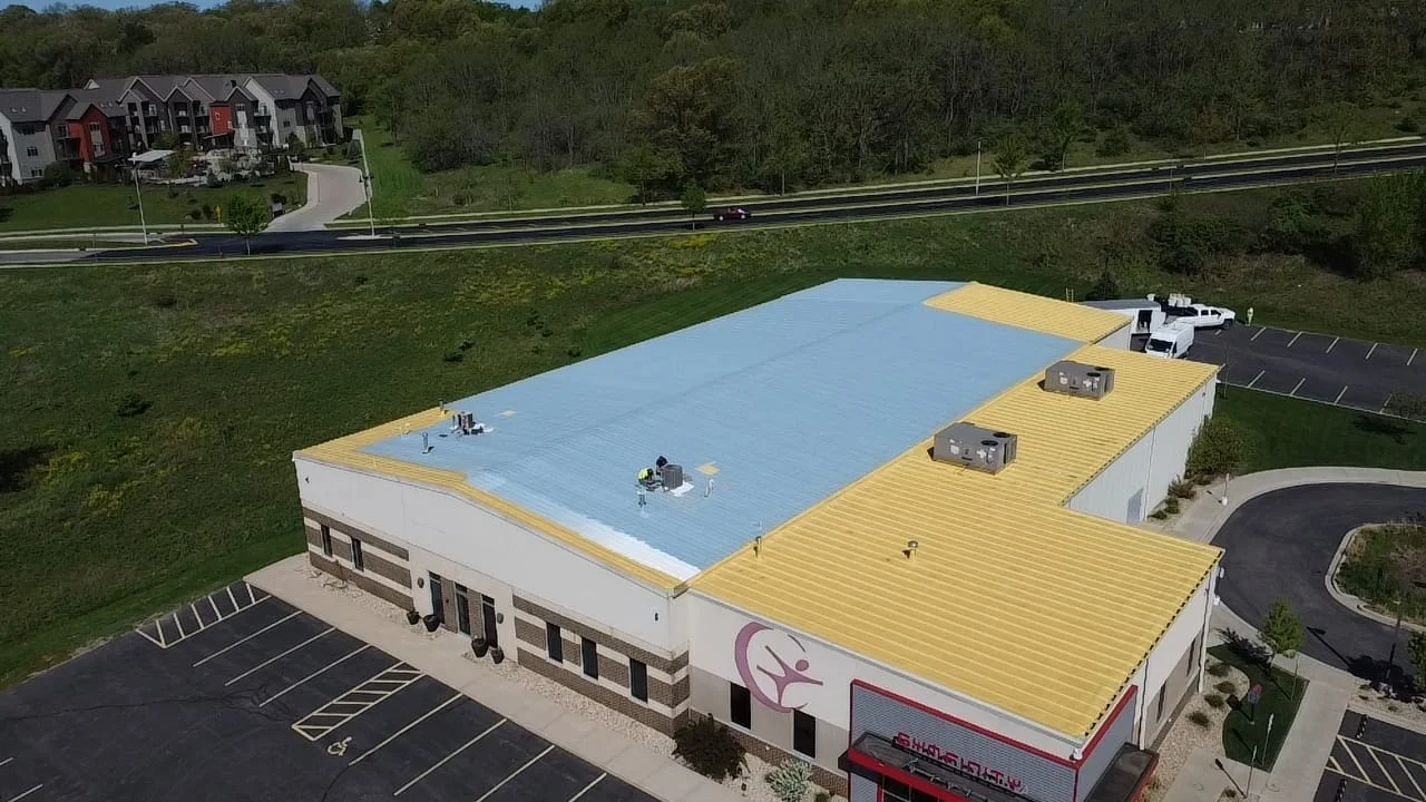 Expert roofing team performing maintenance on a large flat commercial roof - roofing companies wisconsin rapids wi Expert roofing team performing maintenance on a large flat commercial roof - roofing companies wisconsin rapids wi