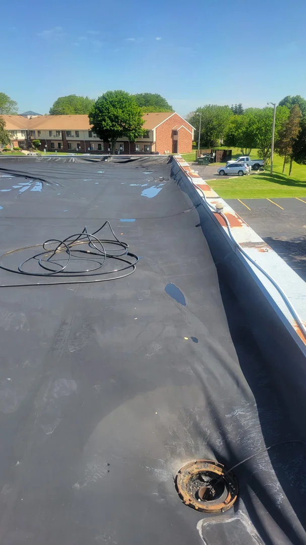 Commercial flat roof with significant ponding water near a drain - epdm leak repair services Commercial flat roof with significant ponding water near a drain - epdm leak repair services