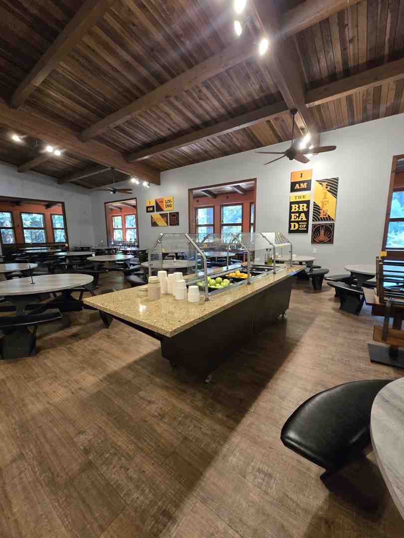 group enjoying meal in dining hall - retreats for large groups