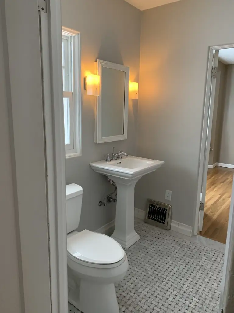 sparkling clean guest bathroom with fresh white towels and a small candle sparkling clean guest bathroom with fresh white towels and a small candle