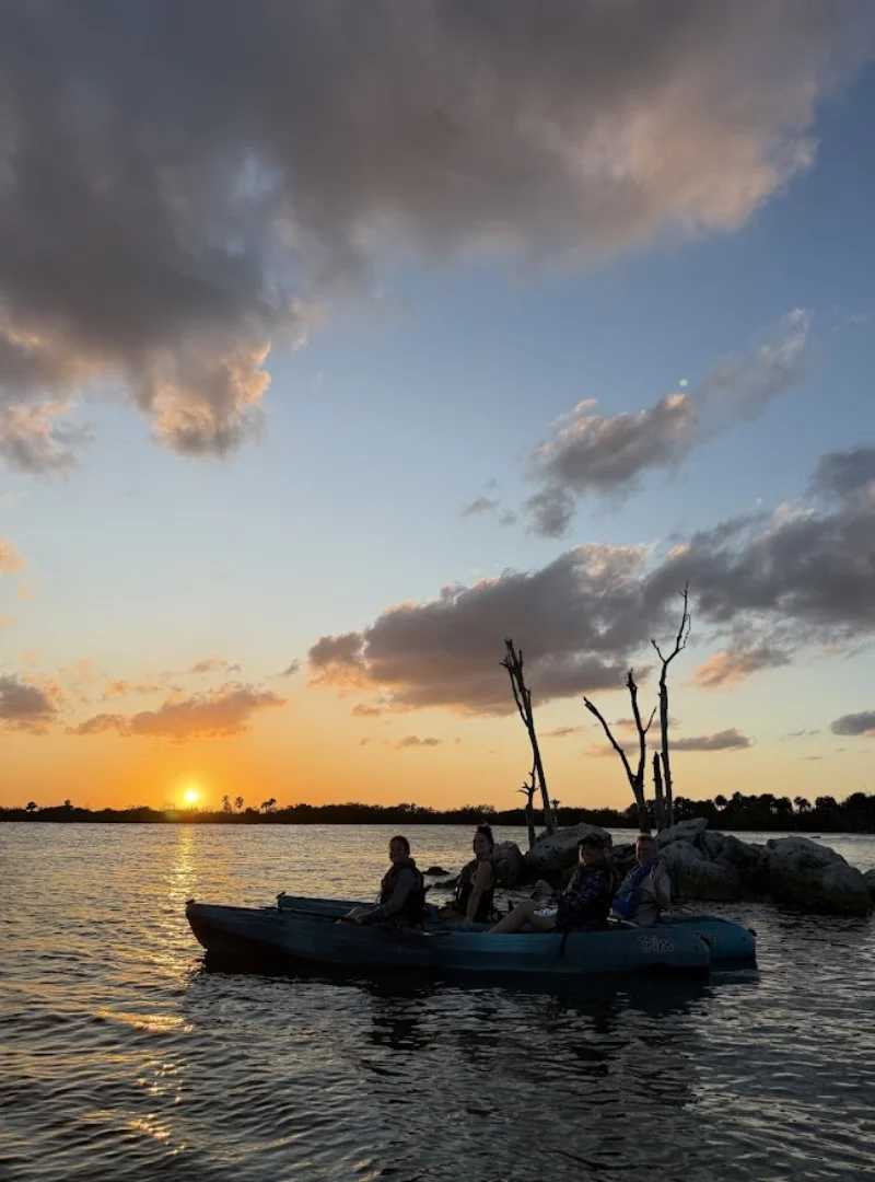 Kayakers preparing to launch on calm Indian River Lagoon water near sunset Kayakers preparing to launch on calm Indian River Lagoon water near sunset