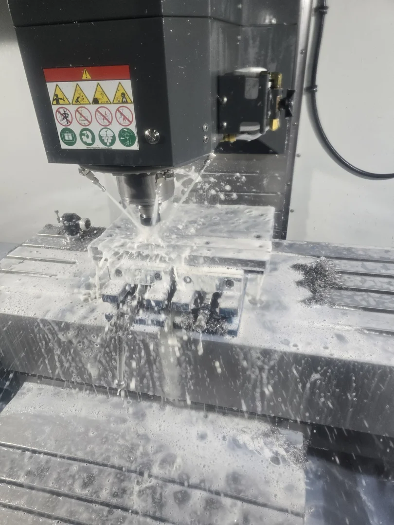 multi-axis CNC milling machine cutting a complex metal part