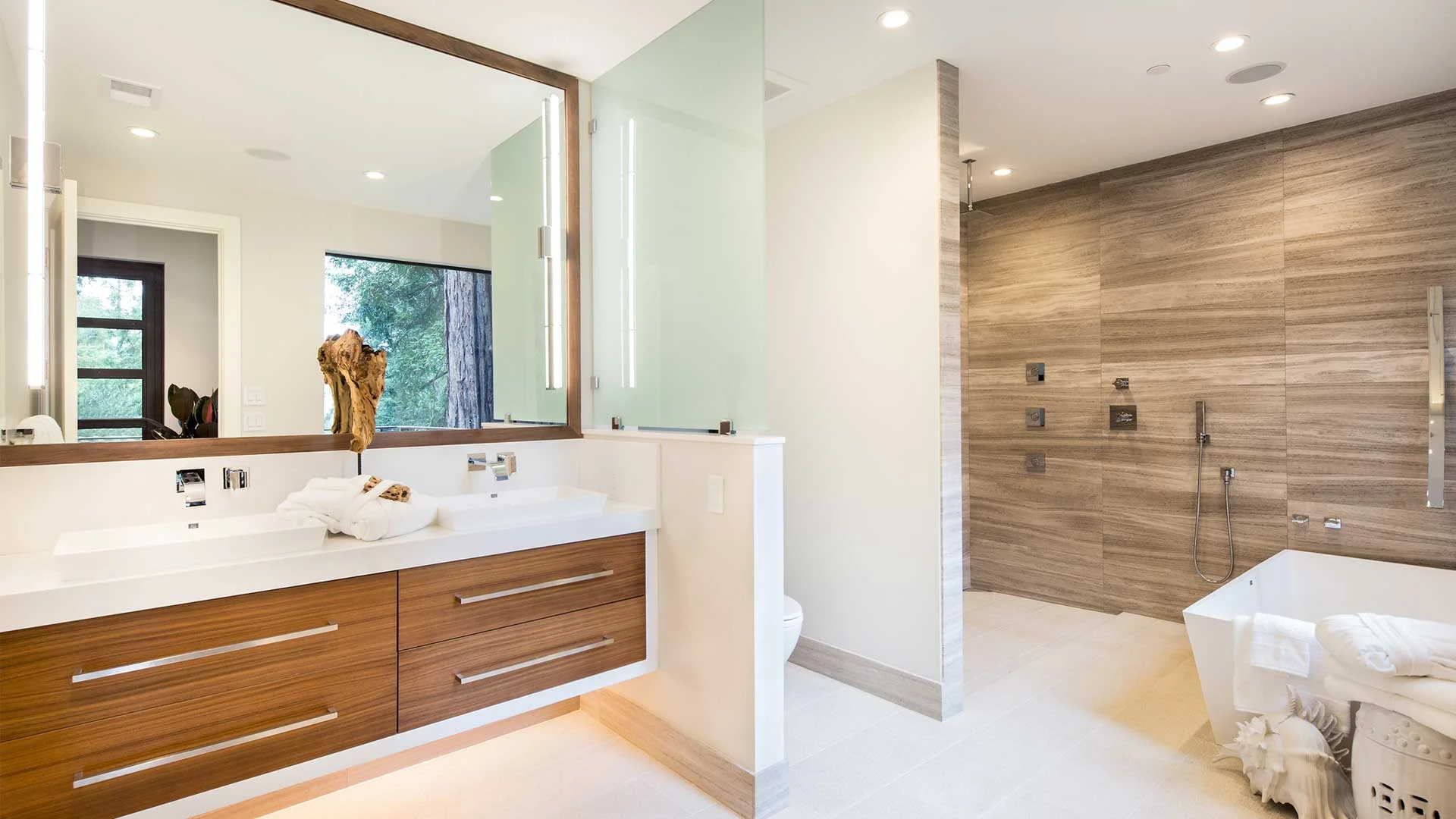 High-rise condo bathroom renovation Chicago IL showing custom glass shower and floating vanity