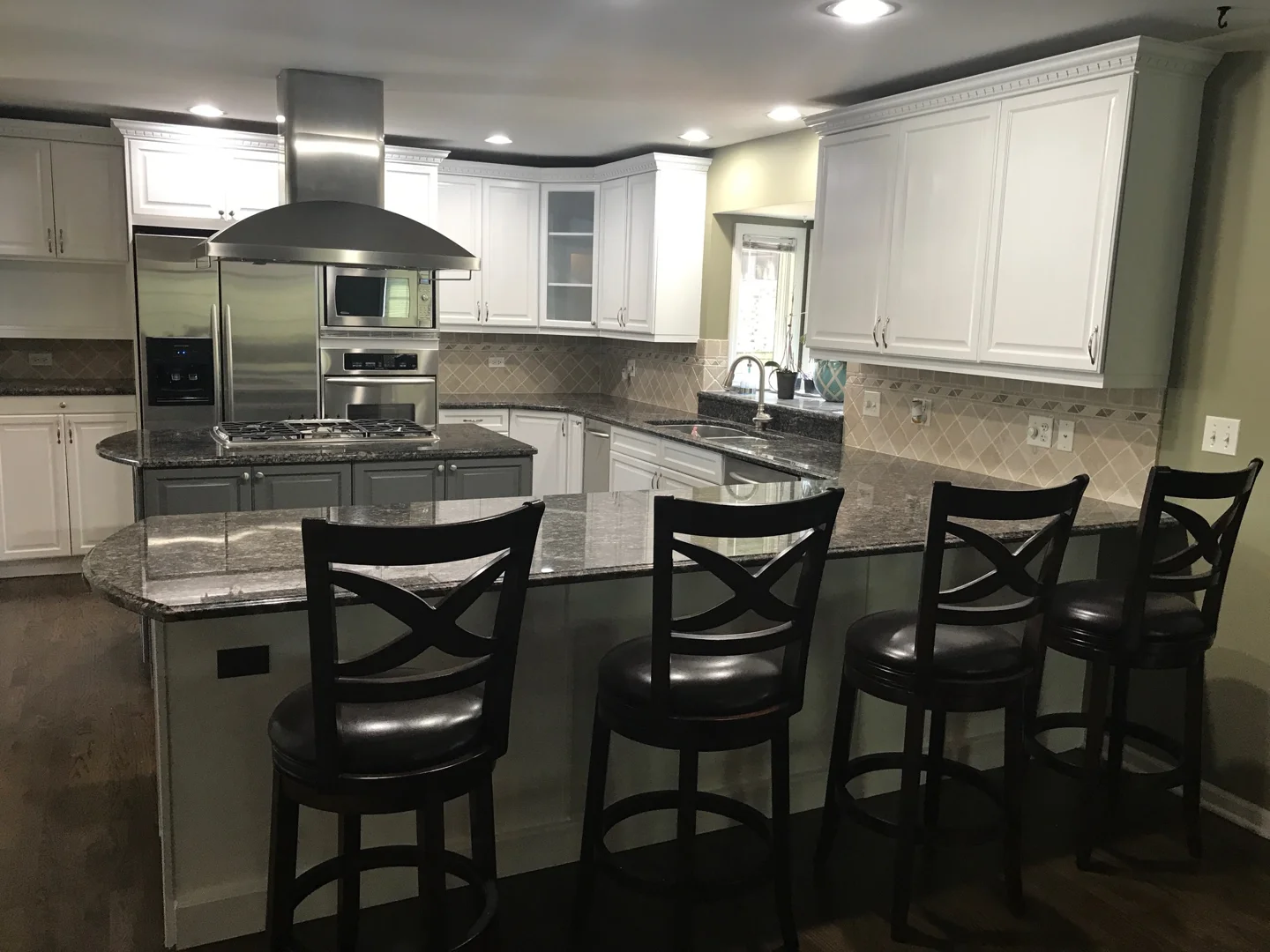Backless stools tucked under a custom kitchen island overhang