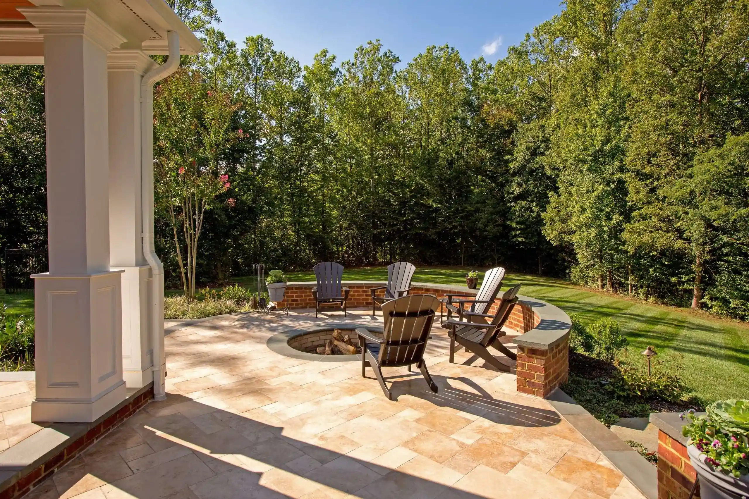 Rattan armchairs by a fireplace - outdoor fireplaces wood burning designs