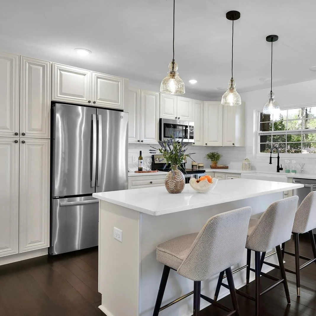 White base cabinets paired with quartz countertops and brass pulls White base cabinets paired with quartz countertops and brass pulls