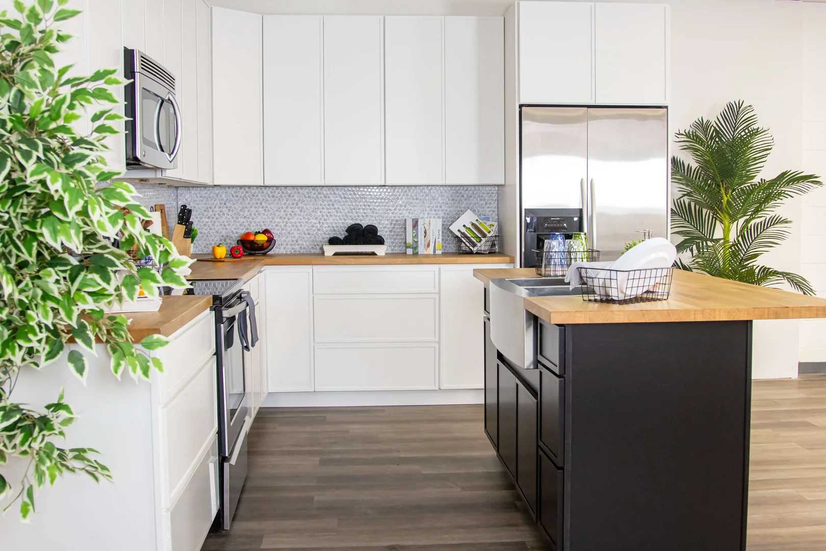 Warm wood butcher block island countertop paired with white shaker perimeter cabinets Warm wood butcher block island countertop paired with white shaker perimeter cabinets