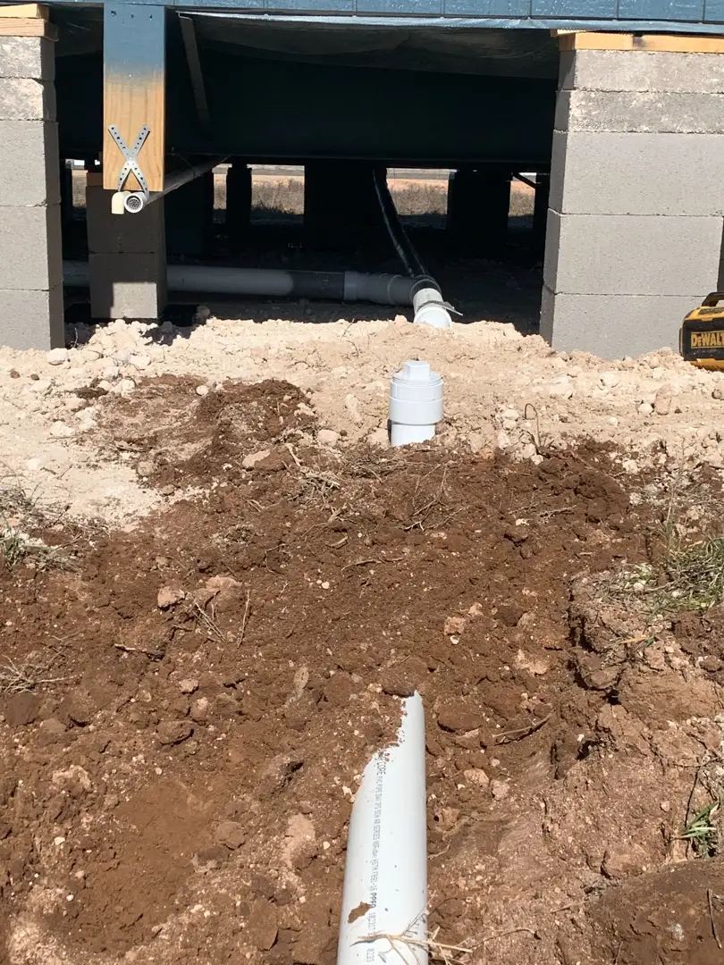 Plumber performing a professional sewer camera inspection in a Lubbock home