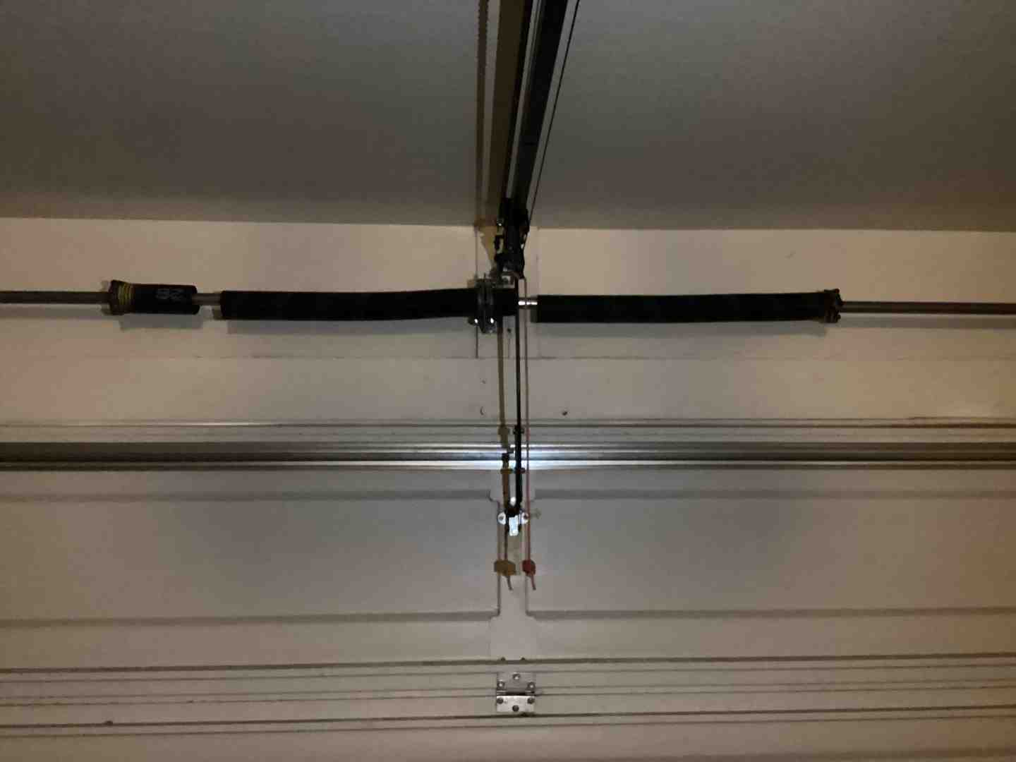close-up of broken torsion spring on garage door - garage door repair phoenix reviews
