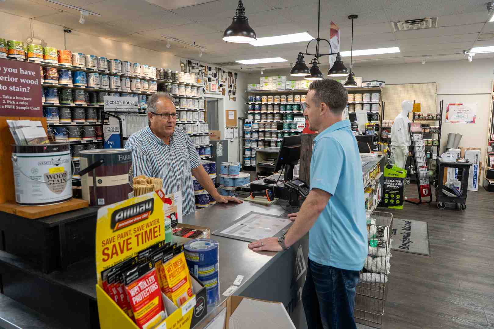 friendly paint store expert assisting a contractor - commercial paint suppliers near me