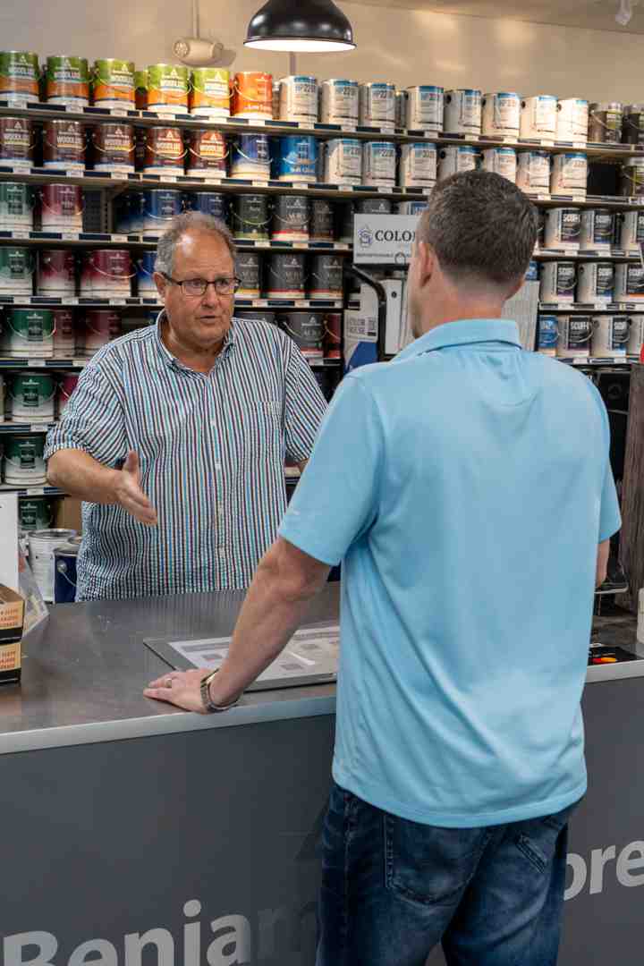 friendly paint store employee helping a customer compare color swatches - Paint store Rhode Island friendly paint store employee helping a customer compare color swatches - Paint store Rhode Island