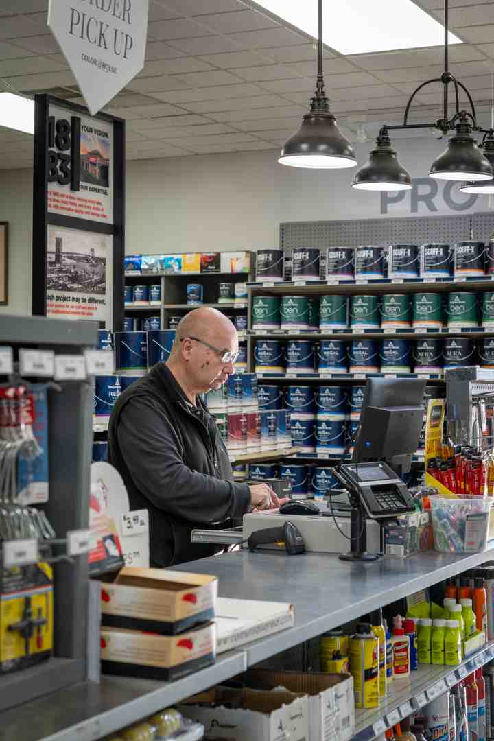 A welcoming paint counter at The Color House, with friendly staff ready to assist customers with color selections and product information - big paint shop near me
