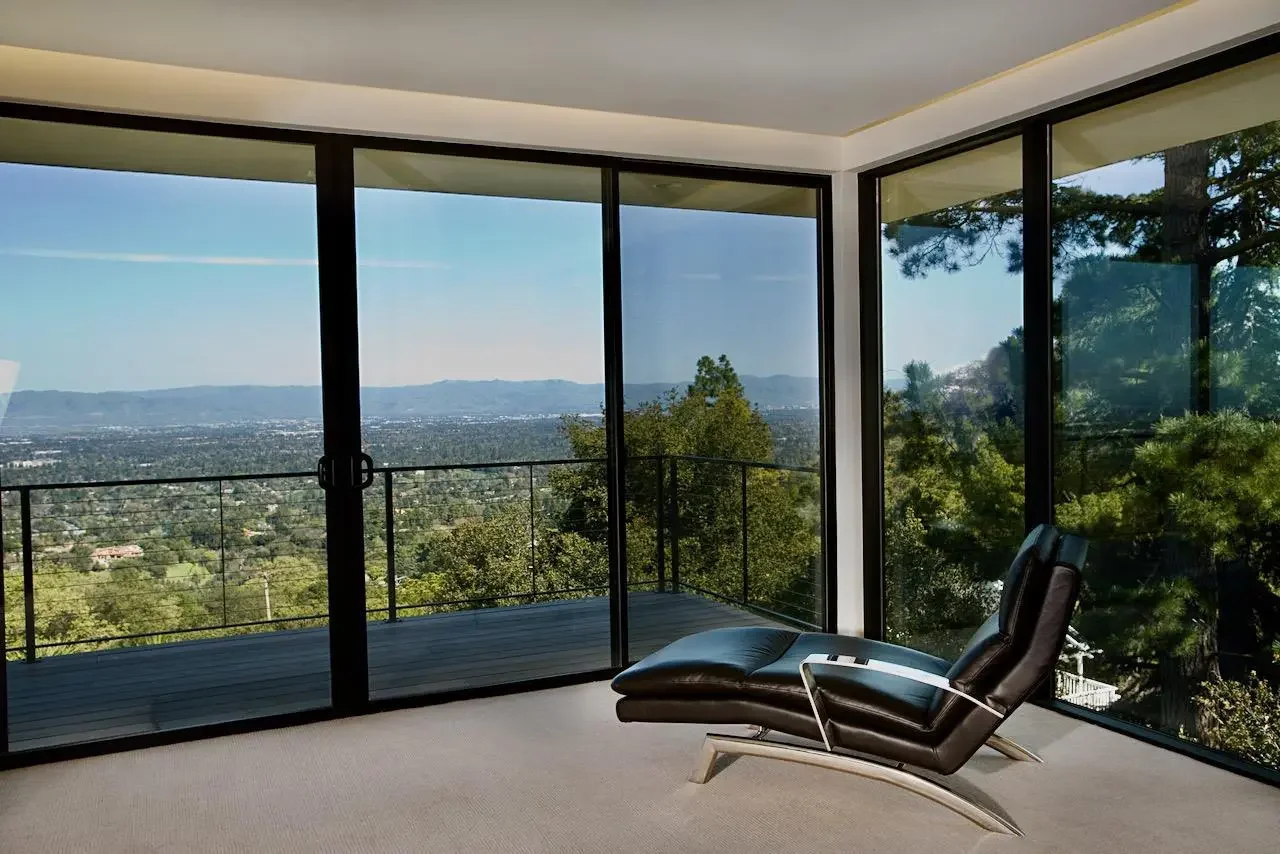 A private suite in a Los Altos Hills estate featuring high-end finishes, a king-sized bed, and a private balcony overlooking