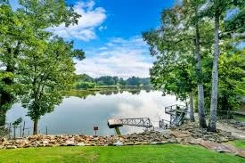 2Poochies Properties lakefront home with a golden retriever on the dock - alabama fenced pet vacation rentals