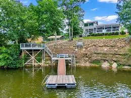 A beautiful lakefront home on Lewis Smith Lake with a private dock and 2Poochies logo - rentals at smith lake alabama