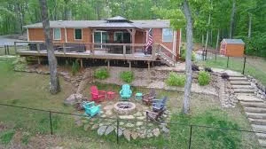 A secure, fenced lakefront yard at a Smith Lake home where a dog is playing safely near the water - smith lake pet cabin