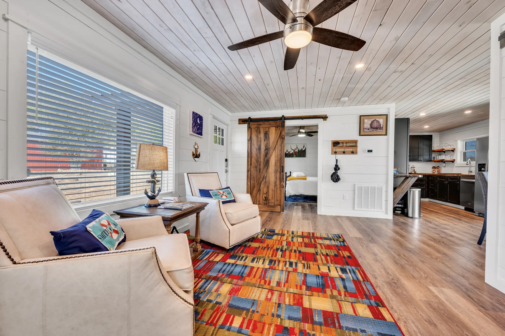Interior of a pet-friendly lakefront home featuring durable flooring, modern furniture, and a dog resting comfortably