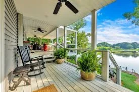 A happy family with two dogs relaxing on a secure, gated lakefront porch overlooking Smith Lake