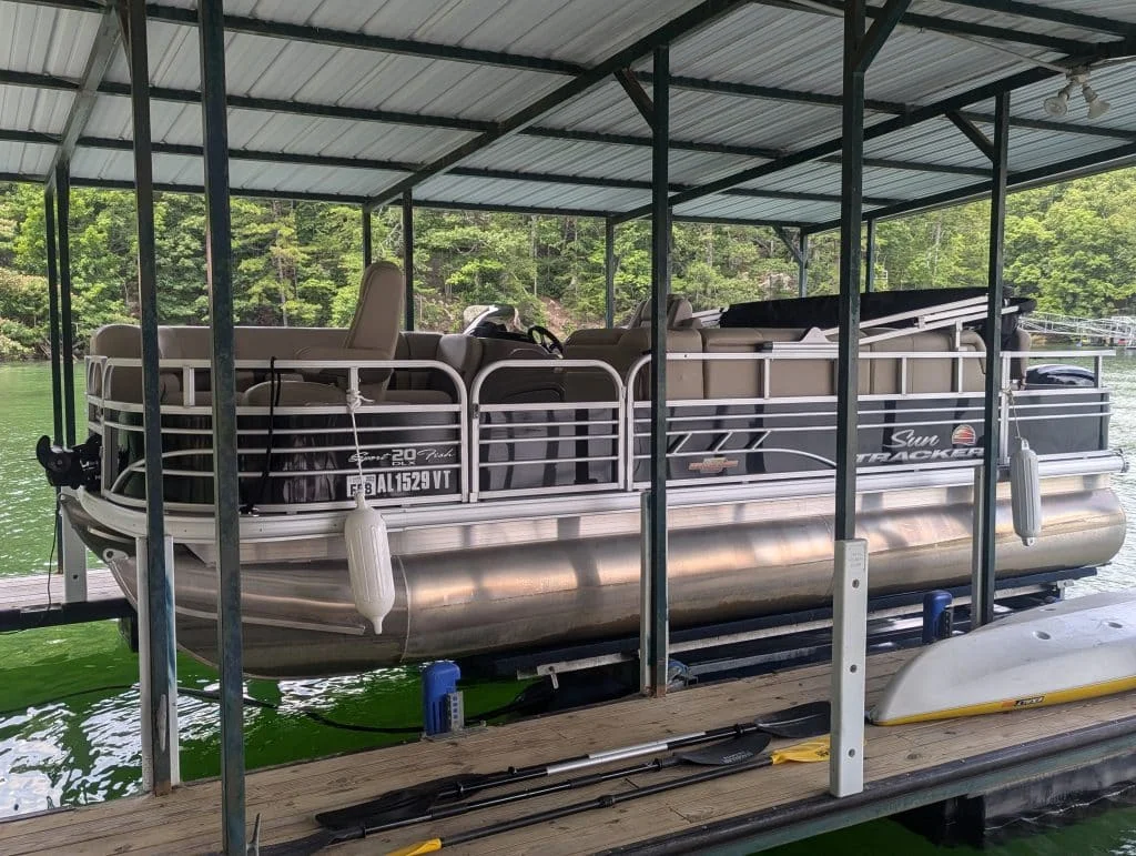 Family enjoying a pontoon boat ride on the clear waters of Smith Lake