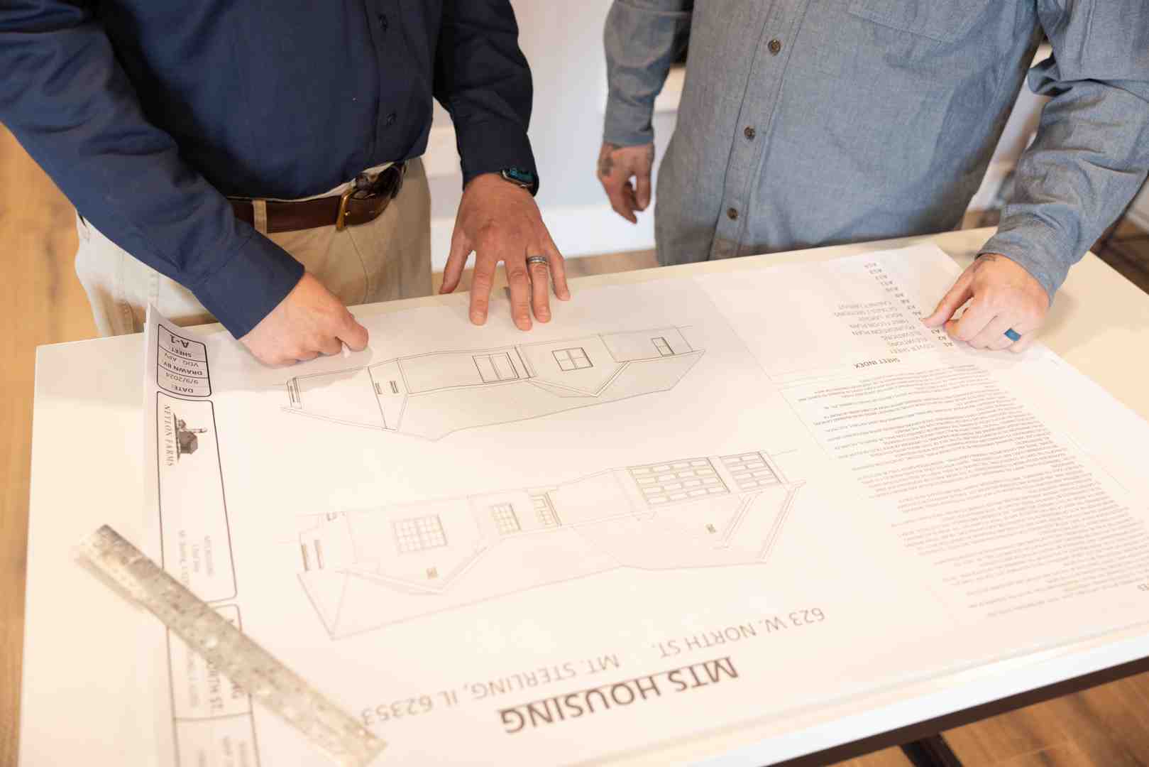 architectural blueprint on a wooden table - builder house near me