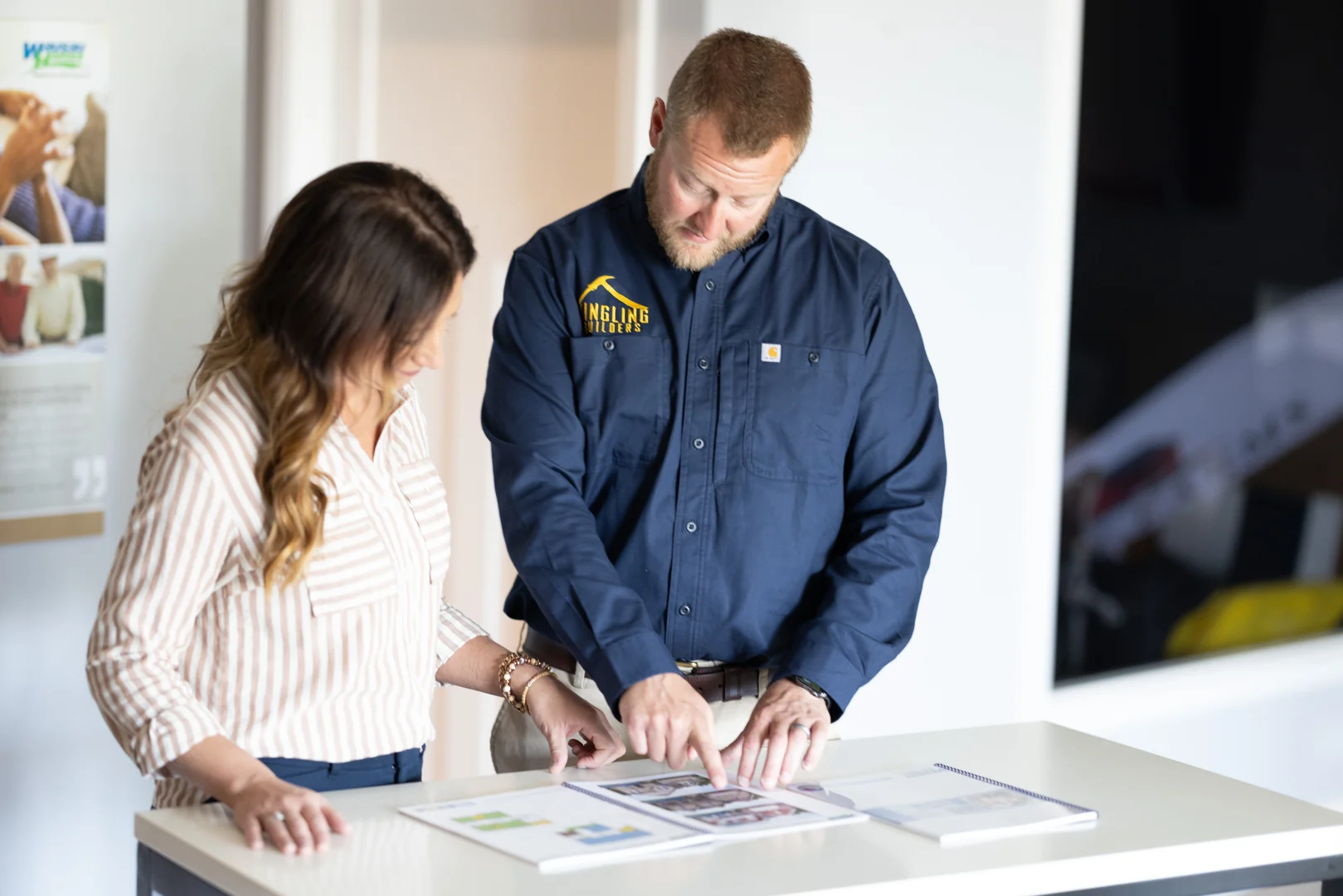 An Illinois custom home builder team reviewing site plans with clients on a scenic rural lot An Illinois custom home builder team reviewing site plans with clients on a scenic rural lot