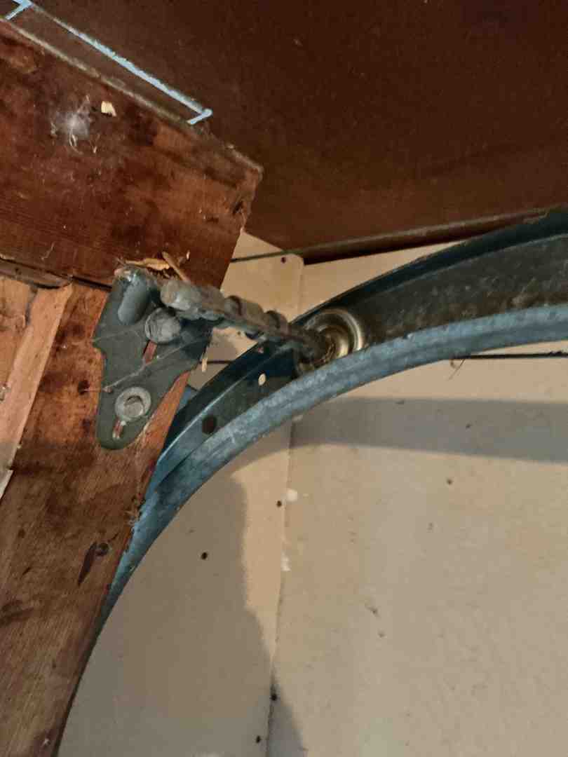 A friendly technician inspecting a garage door system - "Who Can I Call for Same-Day Garage Door Repair in Austin, TX? My Door Is Off Its Track."