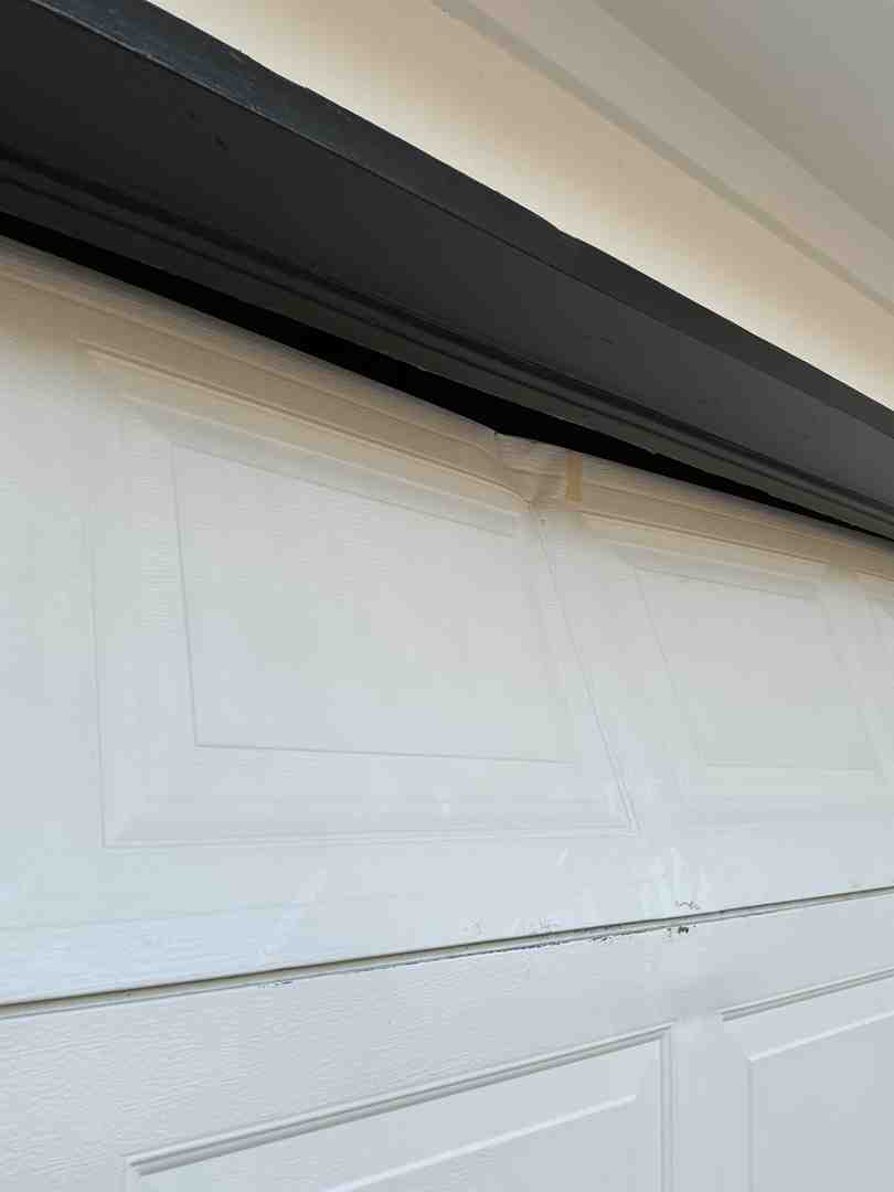 Garage door that is slightly off-track or showing visible wear - best garage door maintenance in cedar park tx