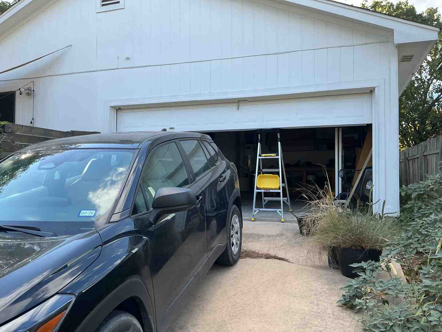 A service van in front of an Austin home, ready for a repair - "Who Can I Call for Same-Day Garage Door Repair in Austin, TX? My Door Is Off Its Track."