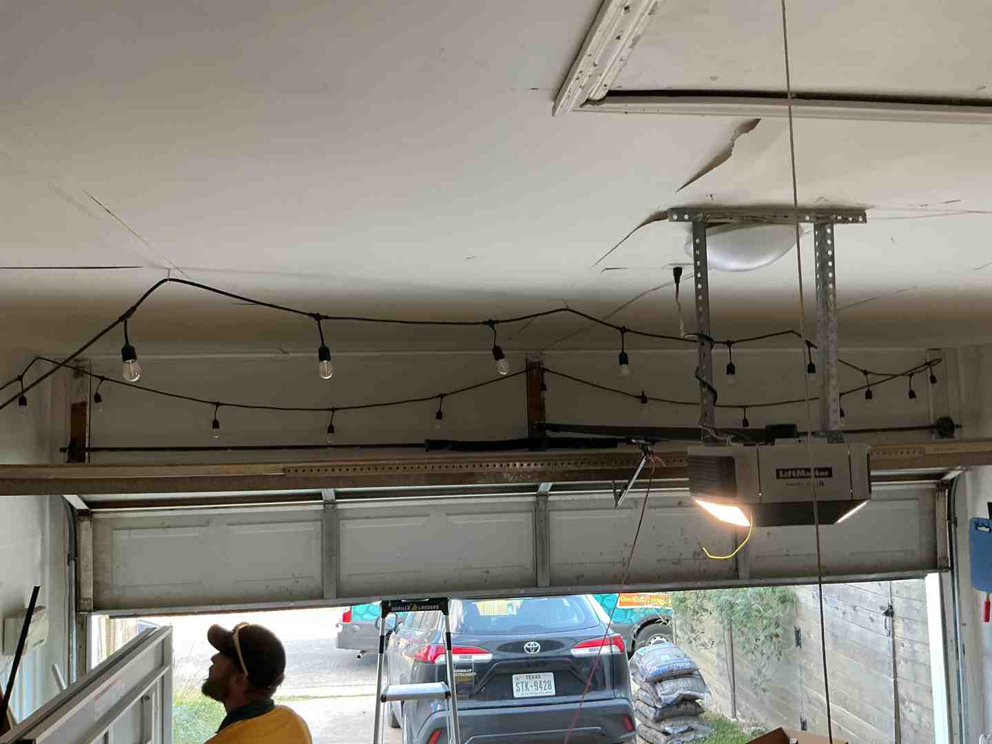 technician inspecting noisy garage door opener - best garage door maintenance in georgetown tx