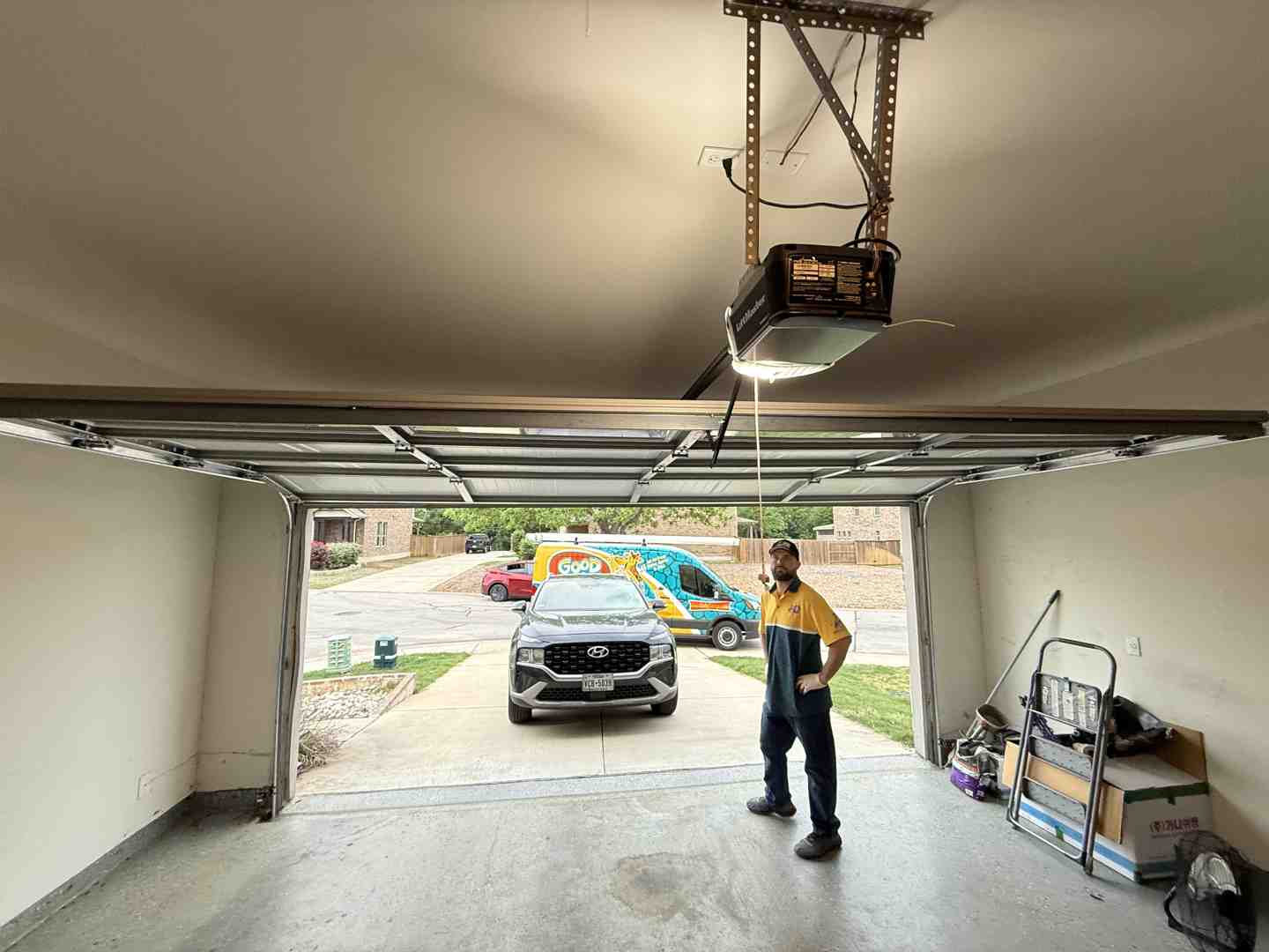 technician inspecting a garage door motor in a Lakeway home - "I need someone to fix my garage opener in Lakeway, TX. Who