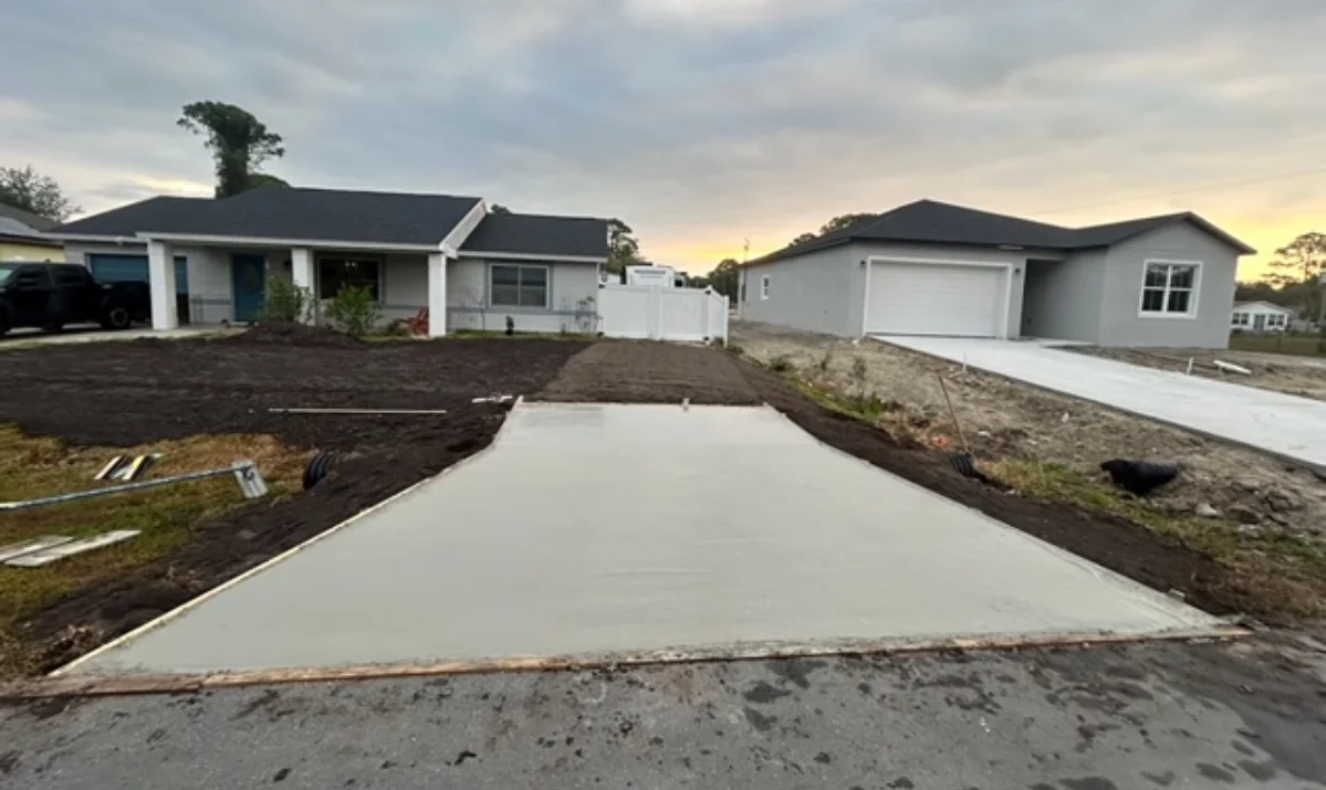 New concrete patio installation in a residential backyard