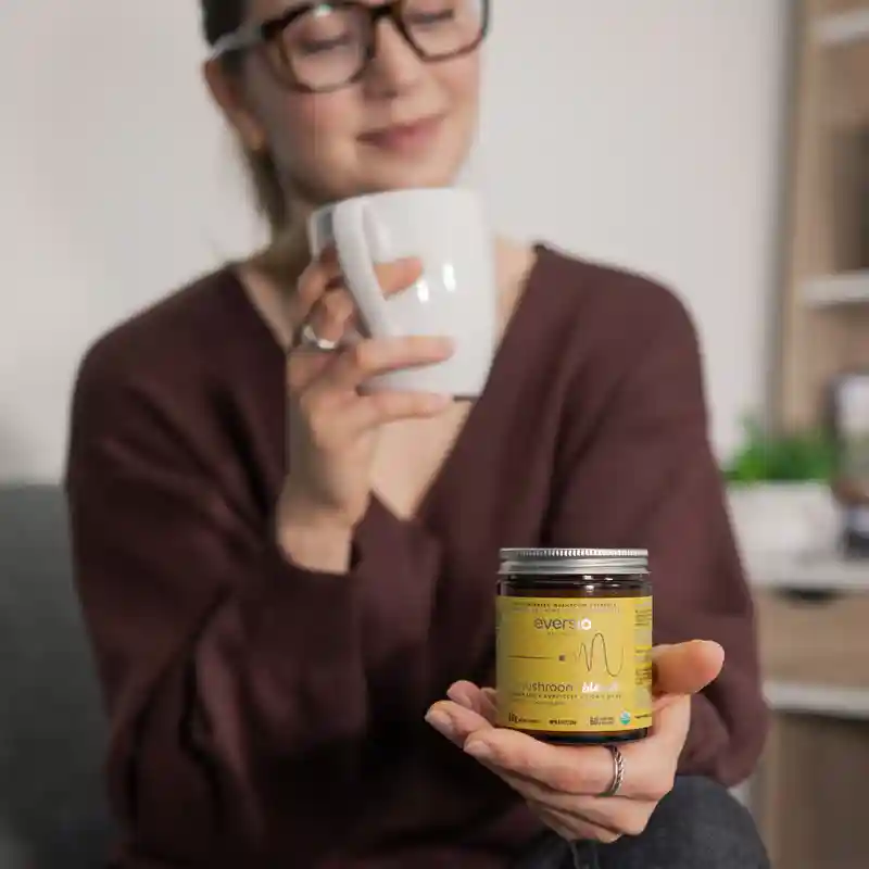 Lifestyle shot of a woman with Eversio product, a high-quality extract made exclusively from the fruiting body, resolving the confusion over mycelium vs fruiting body. Lifestyle shot of a woman with Eversio product, a high-quality extract made exclusively from the fruiting body, resolving the confusion over mycelium vs fruiting body.