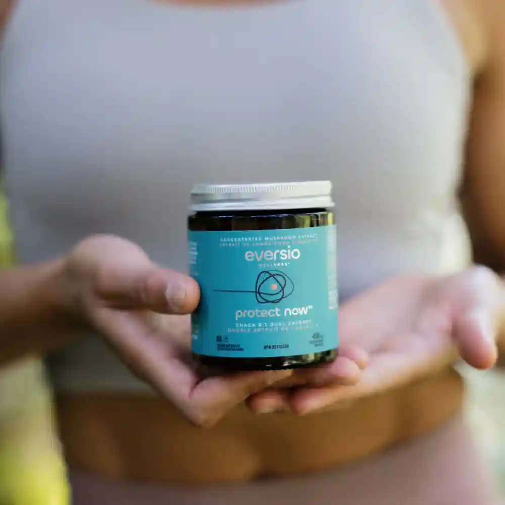 Woman holding a jar of Chaga 8:1 Dual Extract powder, promoting the health benefits and confirming is chaga healthy.