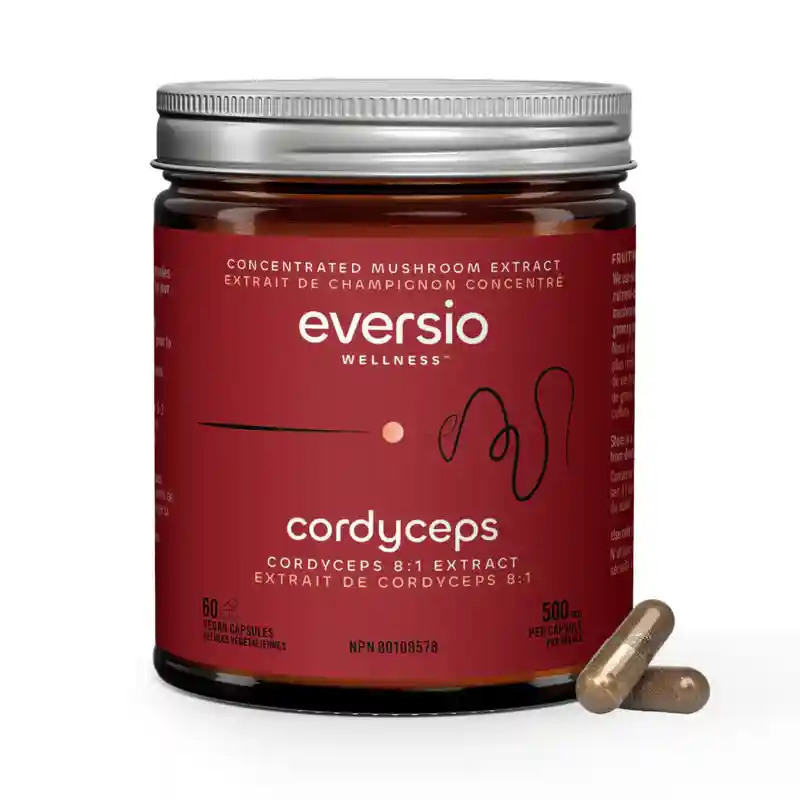 Achieving energy without jitters with Cordyceps 8:1 extract capsules, shown in a premium red glass jar with vegan supplements.
