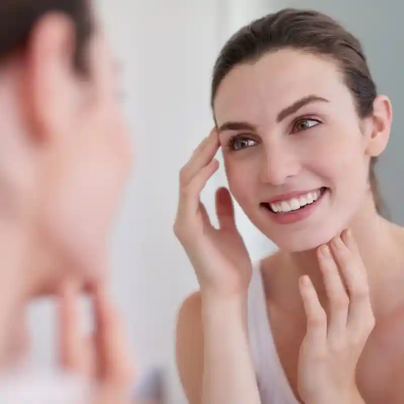 A smiling woman with a clear, glowing complexion, illustrating the long-term benefits of Chaga skin health supplements. A smiling woman with a clear, glowing complexion, illustrating the long-term benefits of Chaga skin health supplements.