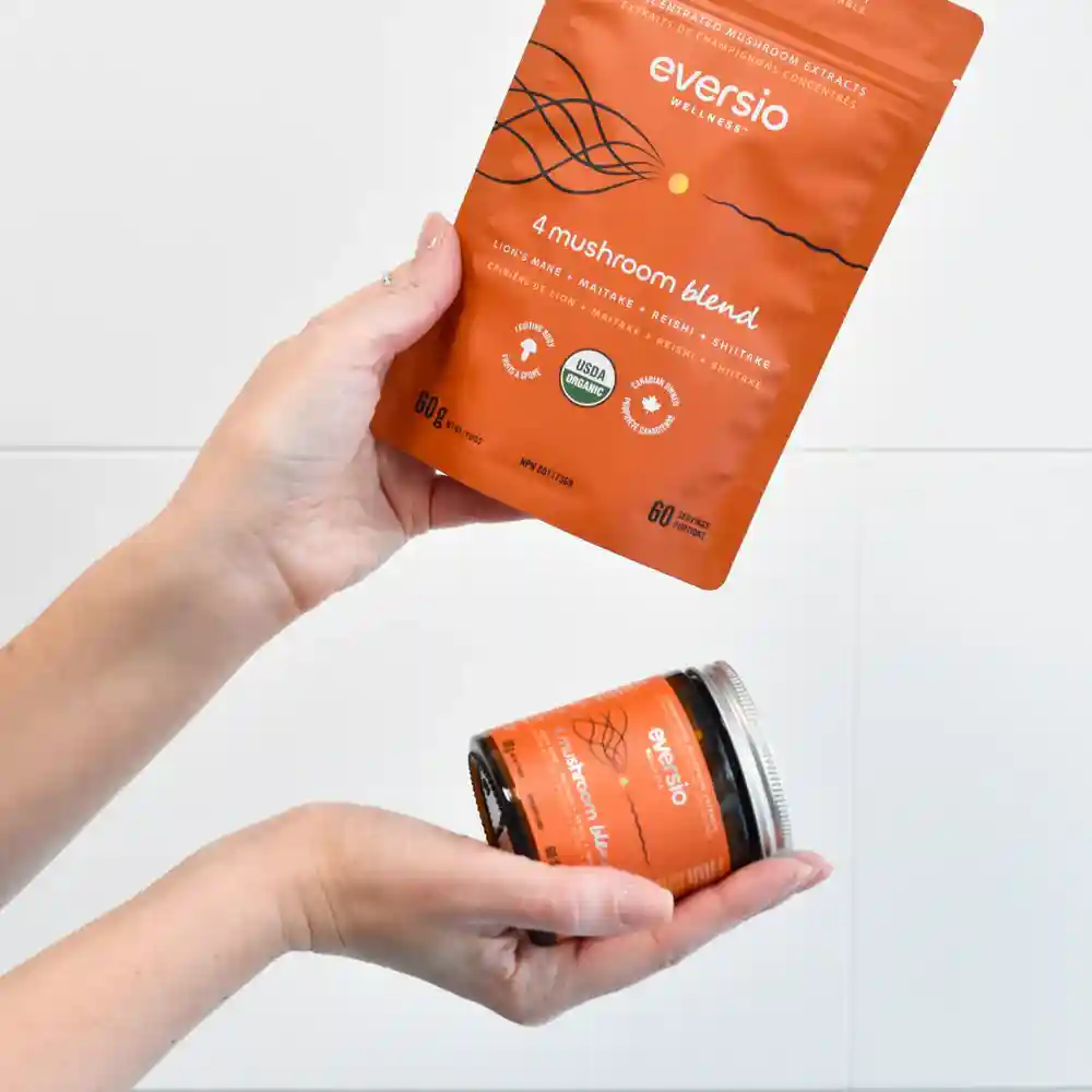 A person holding an Eversio Wellness 4 Mushroom Blend pouch and a glass jar, demonstrating why refillable packaging is the best form of mushroom supplement for sustainability. A person holding an Eversio Wellness 4 Mushroom Blend pouch and a glass jar, demonstrating why refillable packaging is the best form of mushroom supplement for sustainability.