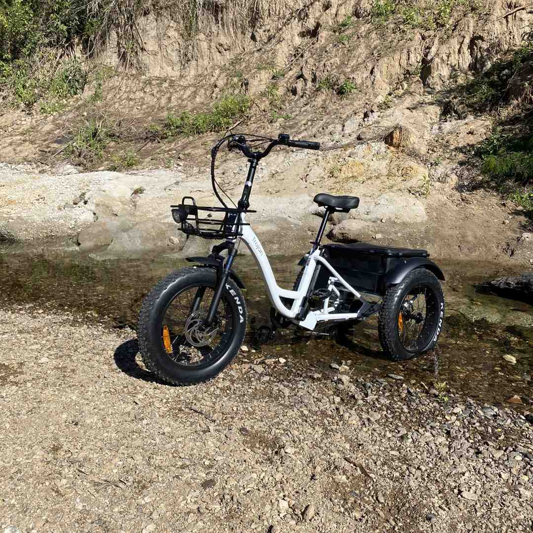 person checking e-bike tire pressure - electric bicycle tune-up