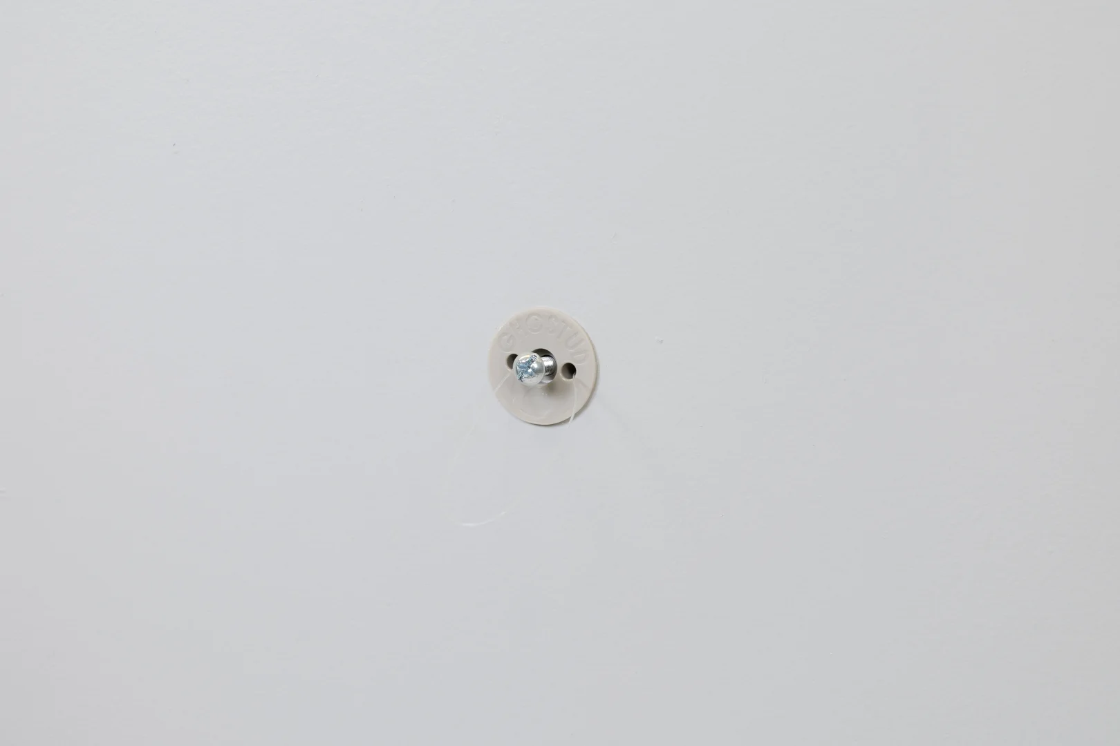 Installer inspecting wall material at an electrical outlet Installer inspecting wall material at an electrical outlet