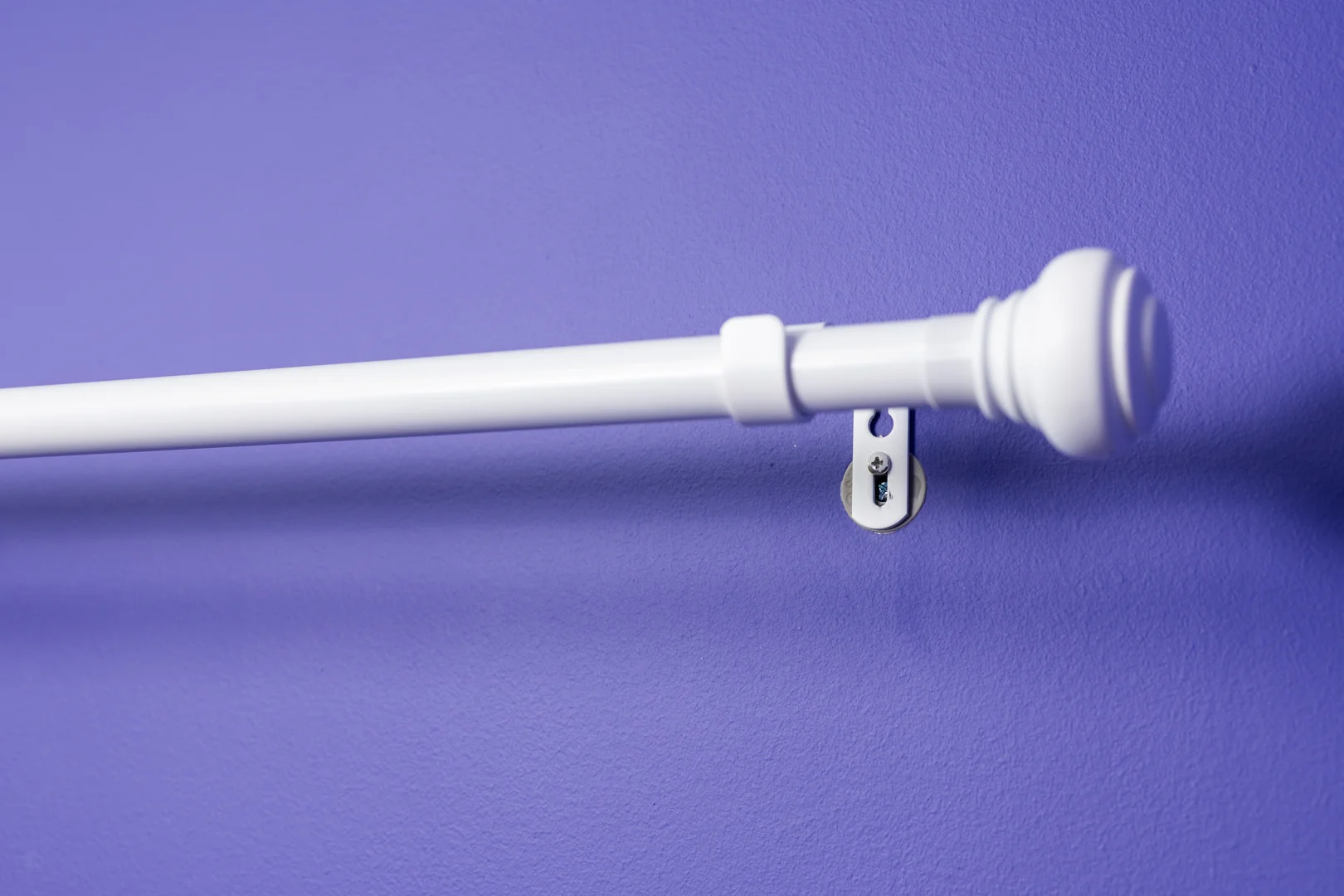 Leveling curtain rod brackets above window frame