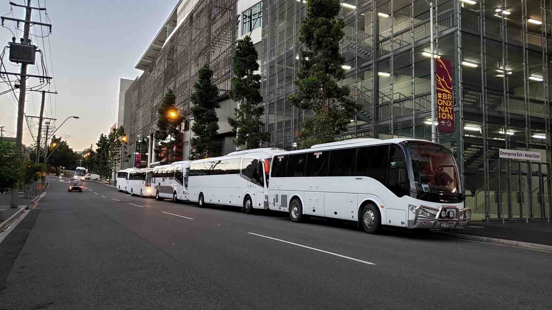 61-seat coach parked near a corporate venue - bus transportation for corporate event