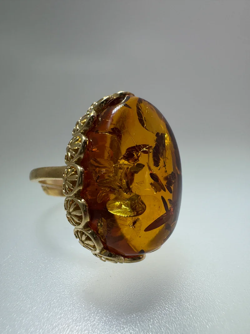 A cognac amber solitaire ring set in a thick, oxidized sterling silver band - mens baltic amber rings