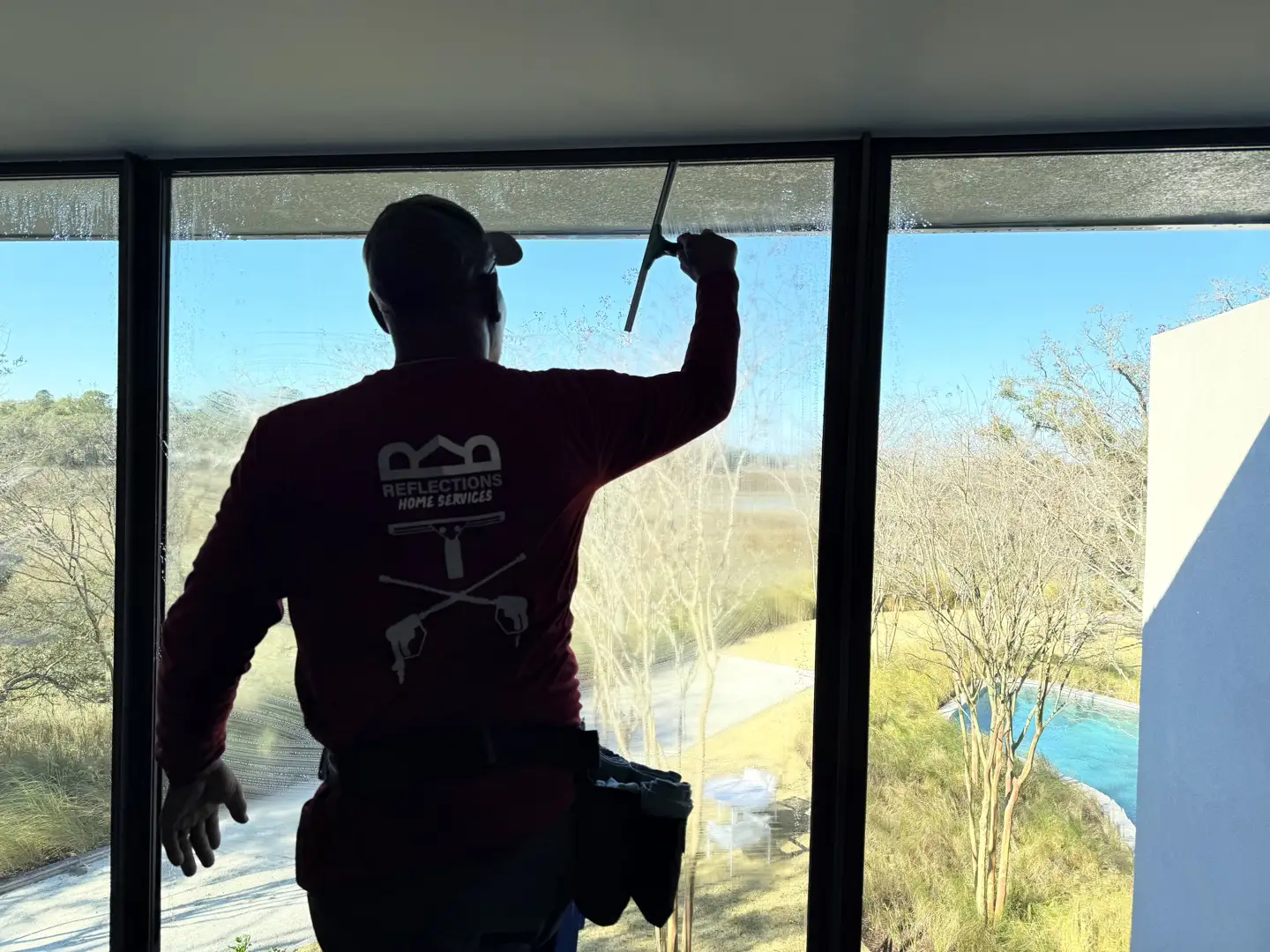 Technician performing precision detailing on a historic window frame in Charleston - luxury window cleaning charleston Technician performing precision detailing on a historic window frame in Charleston - luxury window cleaning charleston