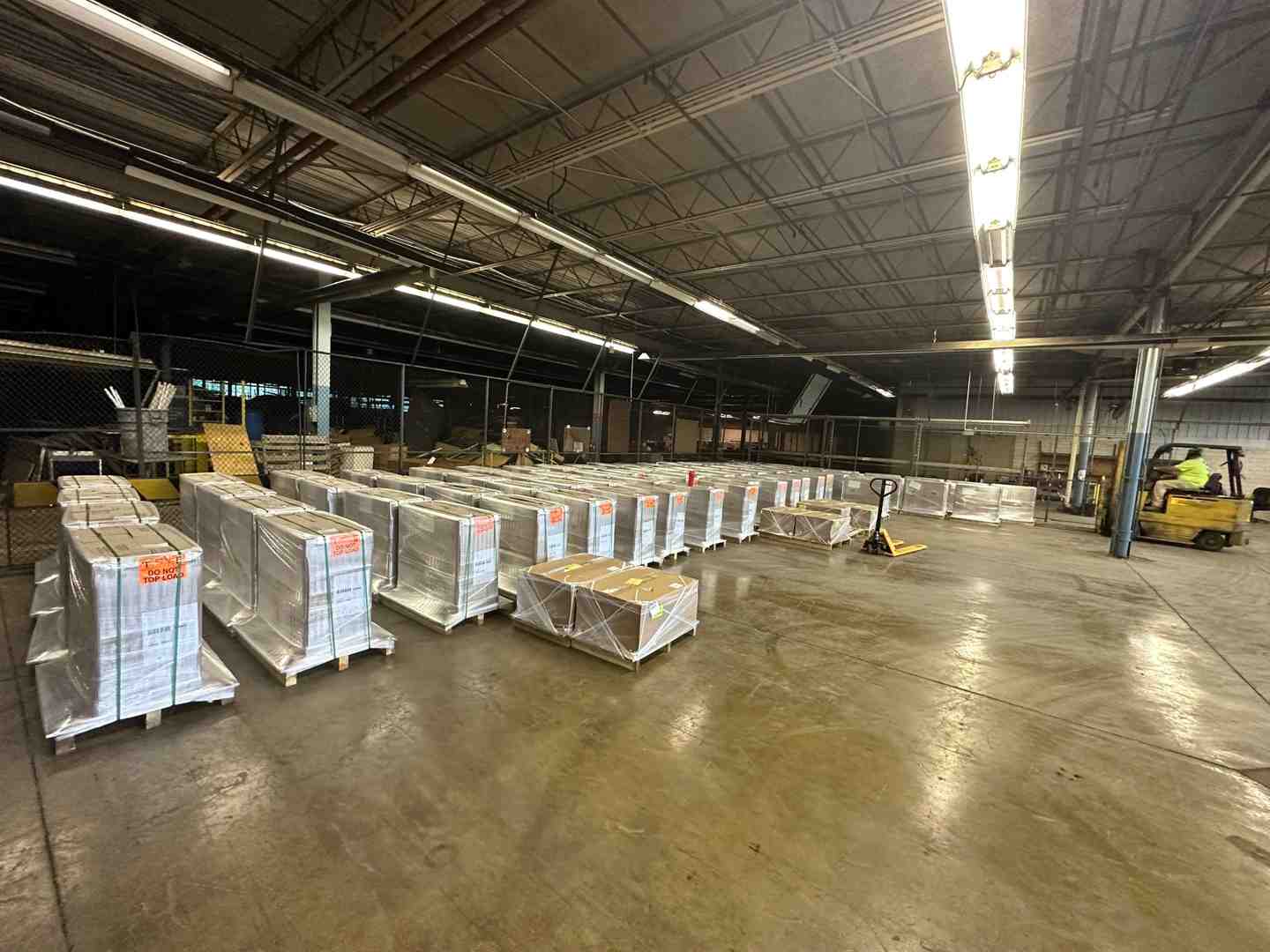 A selective pallet rack system with a forklift accessing a pallet. - industrial warehouse pallet racking A selective pallet rack system with a forklift accessing a pallet. - industrial warehouse pallet racking