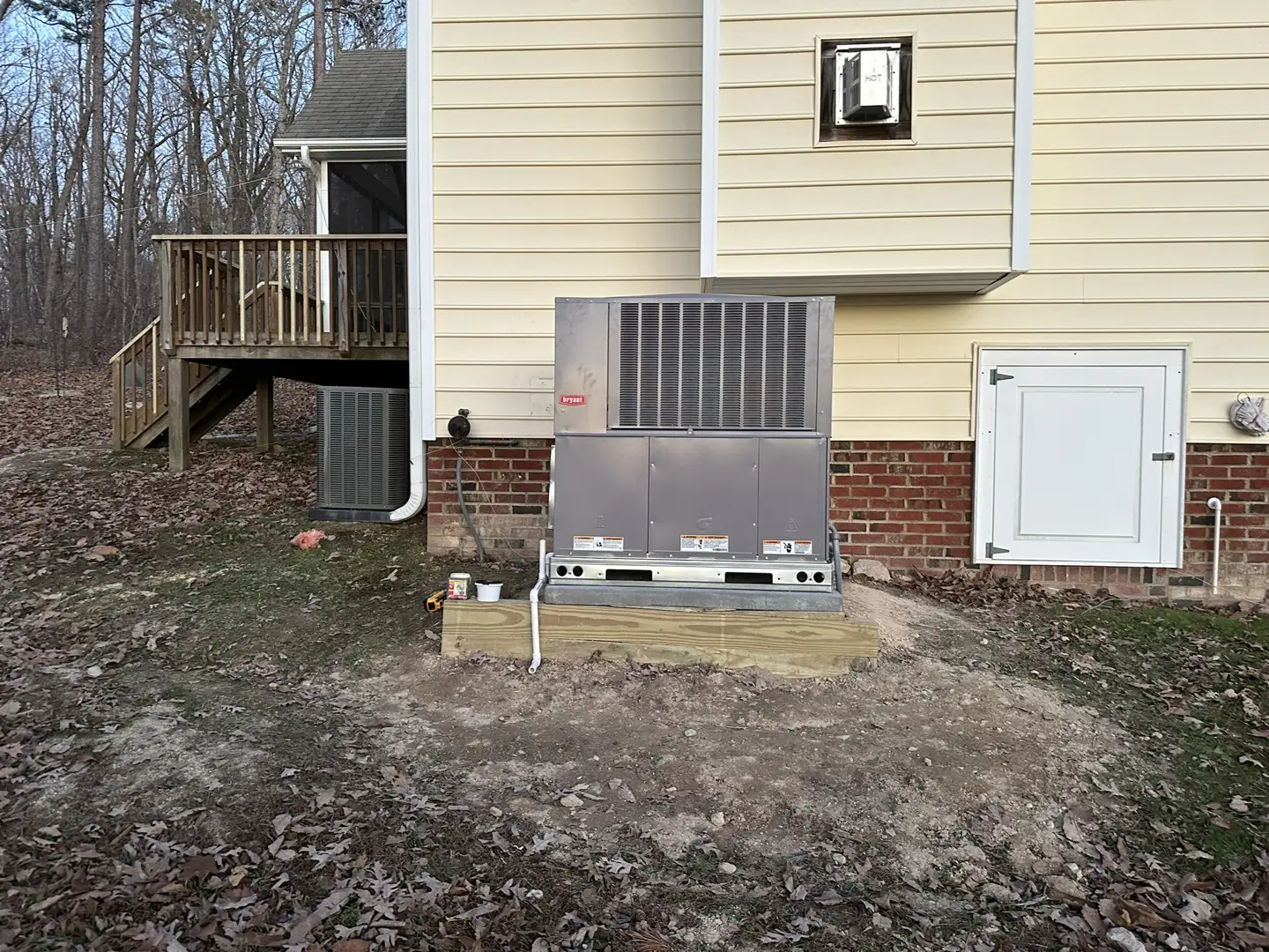 technician inspecting outdoor condenser unit