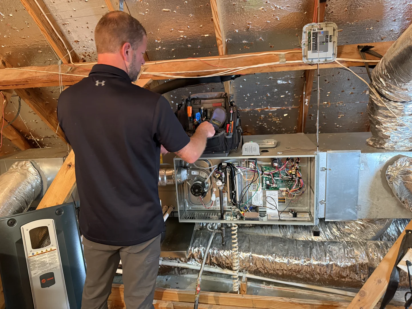 Technician diagnosing an aging air handler unit