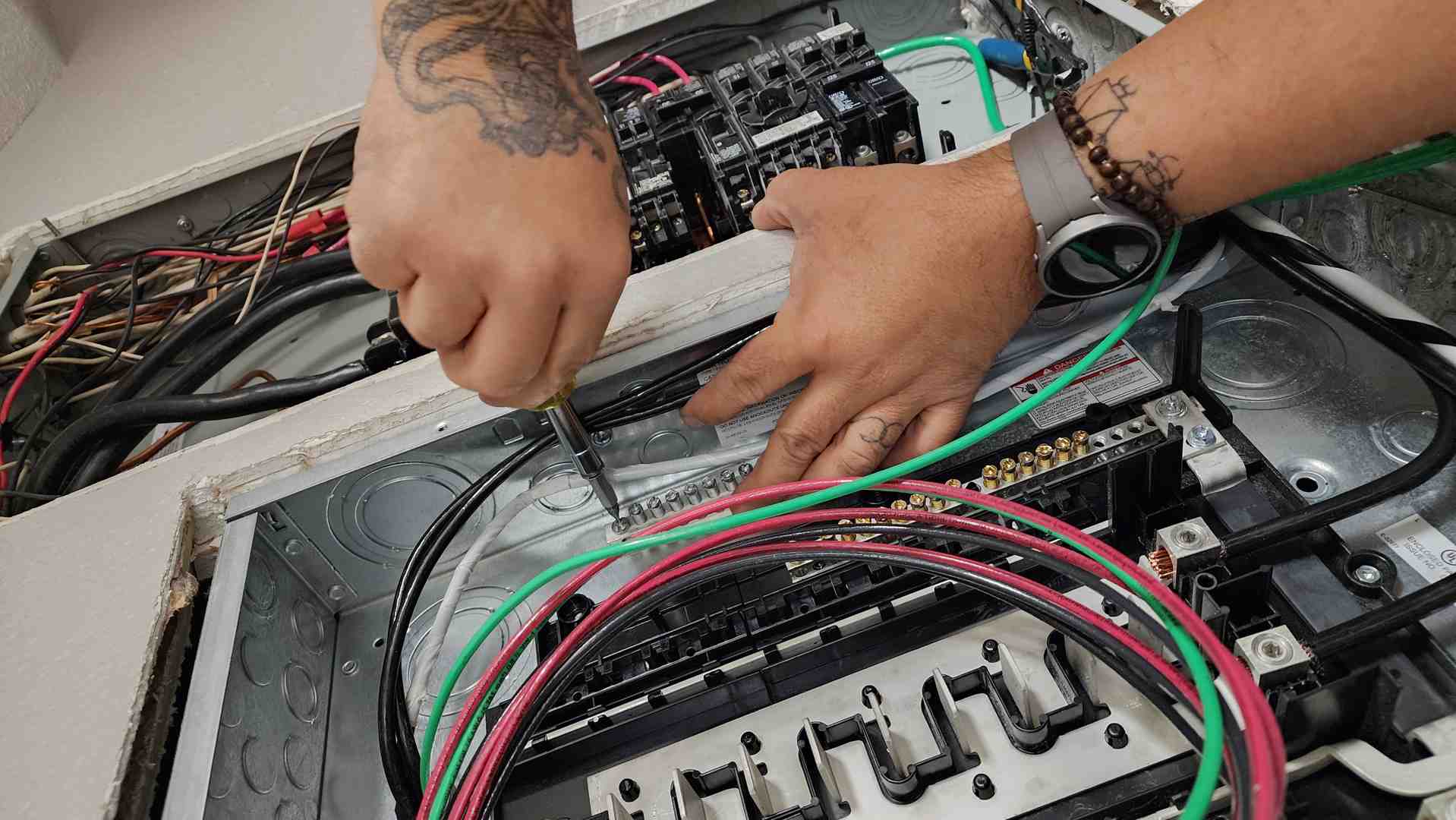 licensed electrician in a clean uniform carefully installing a new circuit in a modern home - is it safe to do your own licensed electrician in a clean uniform carefully installing a new circuit in a modern home - is it safe to do your own